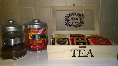 a table with two jars of tea and a wooden box at La Casa di Fabio in Rome