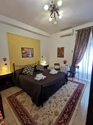 a bedroom with a large bed in a room at B&B Divina Roma in Rome