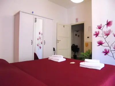 a room with a bed with two towels on it at B&B Divina Roma in Rome