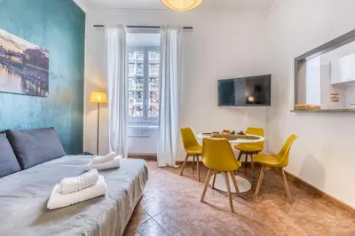 a room with a bed and a table and chairs at La Casetta Trastevere in Rome