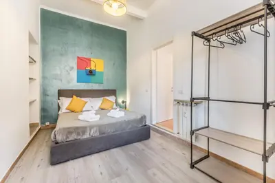 a bedroom with a bed and a staircase at La Casetta Trastevere in Rome