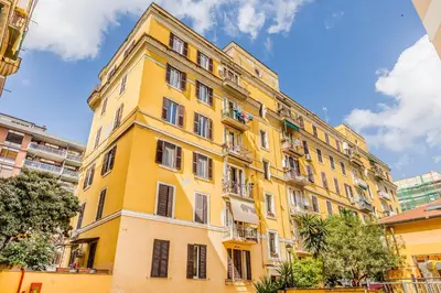 a yellow building withwindows and balconies on it at La Casetta Trastevere in Rome