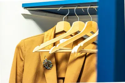 a jacket is hanging on a rack in a closet at The Hive - Holiday Home in Trastevere in Rome