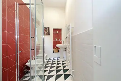 a bathroom with a black and white checkered floor at Casa Giubbonari con terrazzo in Rome