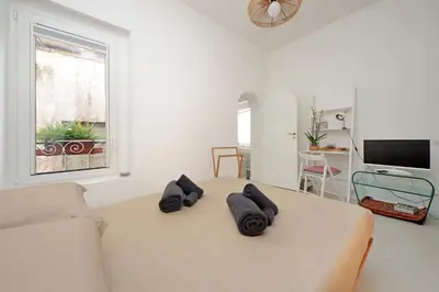 a white room with a bed and a couch at Casa Giubbonari con terrazzo in Rome