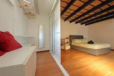 a bedroom with a bed in the middle of a room at Casa Giubbonari con terrazzo in Rome