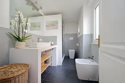 a bathroom with a sink and a tub and a toilet at Casa Giubbonari con terrazzo in Rome