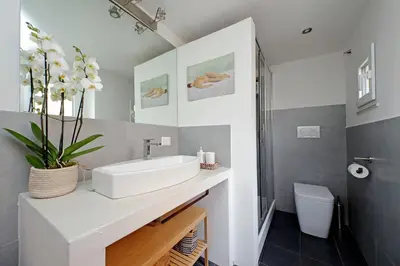 a bathroom with a white sink and a toilet at Casa Giubbonari con terrazzo in Rome