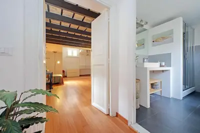 a hallway of a home with white walls and wooden floors at Casa Giubbonari con terrazzo in Rome