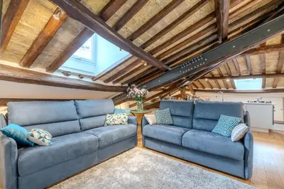two blue couches in a living room with wooden ceilings at Dimora Capo di Ferro in Rome