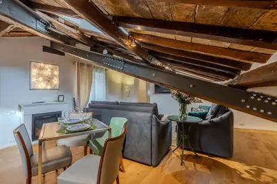 a living room with a table and chairs at Dimora Capo di Ferro in Rome