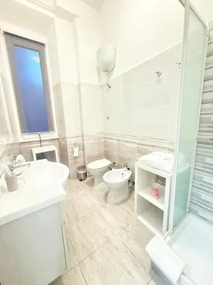 a bathroom with a sink and a toilet and a shower at The house Of Brindisi in Rome