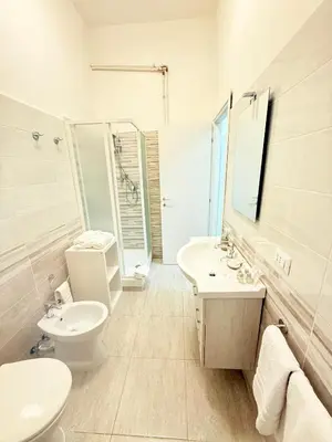 a white bathroom with a sink and a toilet at The house Of Brindisi in Rome