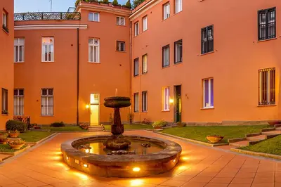 a courtyard with a fountain in front of a building at Exclusive retreat between history and comfort in Rome