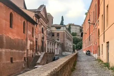 an empty street in an old city with buildings at Exclusive retreat between history and comfort in Rome