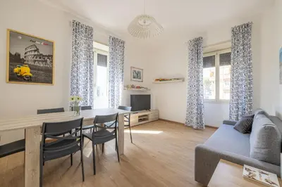 a living room with a table and a couch at Casa EMMA, casa vacanze Aurelio in Rome