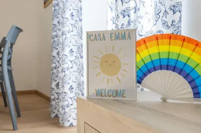 a book on a shelf next to a rainbow at Casa EMMA, casa vacanze Aurelio in Rome