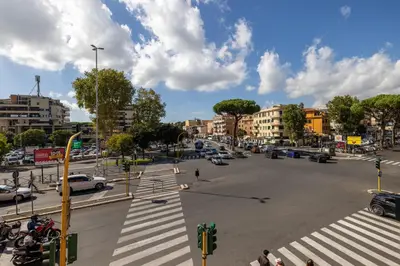 a busy city street with cars and a crosswalk at Casa EMMA, casa vacanze Aurelio in Rome