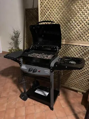 a bbq grill sitting on a stand in a room at L'Attichetto di via Padova in Rome