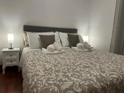 a bedroom with a bed with two towels on it at L'Attichetto di via Padova in Rome
