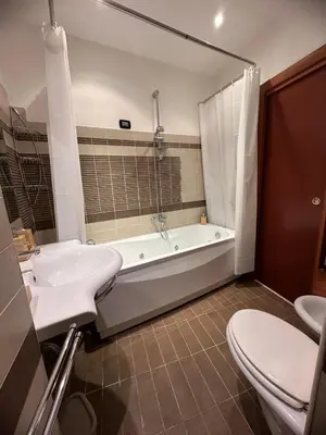 a bathroom with a tub and a sink and a toilet at L'Attichetto di via Padova in Rome