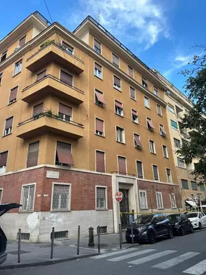 a large building with cars parked in front of it at L'Attichetto di via Padova in Rome
