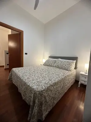 a bedroom with a bed with a white bedspread at L'Attichetto di via Padova in Rome