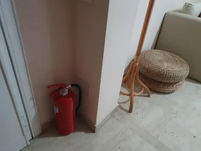 a red fire hydrant in a corner of a room at Laura's RHome in Rome
