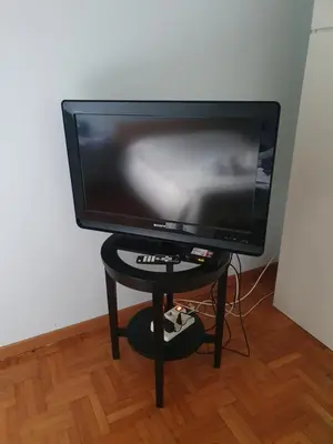 a flat screen tv sitting on a small table at Laura's RHome in Rome