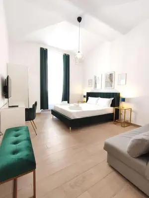 a large room with two beds and a couch at The Gold Apartment in Rome