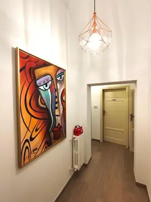 a painting hanging on a wall in a hallway at The Gold Apartment in Rome