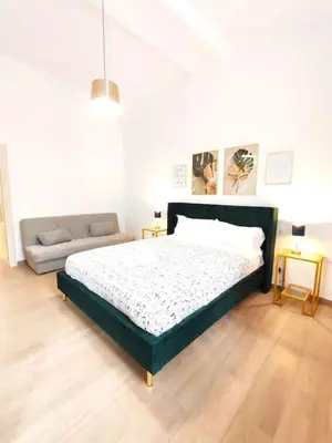 a bedroom with a large bed and a couch at The Gold Apartment in Rome