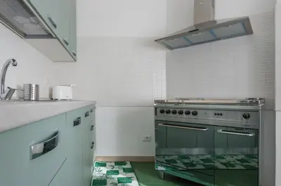 a kitchen with a stove and a sink at Rebecca Apartment in Rome