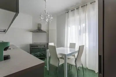 a dining room with a table and chairs in a kitchen at Rebecca Apartment in Rome