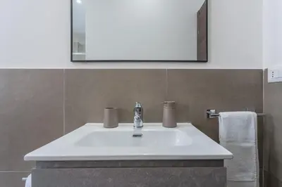 a bathroom with a white sink and a mirror at Rebecca Apartment in Rome