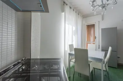 a kitchen with a table and chairs and a dining room at Rebecca Apartment in Rome