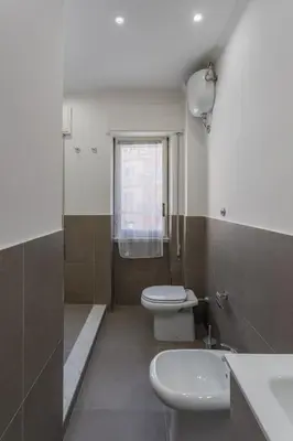 a bathroom with a toilet and a sink at Rebecca Apartment in Rome