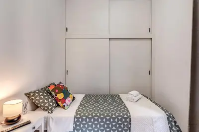 a bedroom with a bed and white cabinets at Oasis Apartment Trastevere in Rome