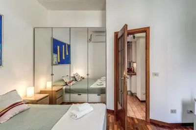 a bedroom with a bed and a mirror at Oasis Apartment Trastevere in Rome