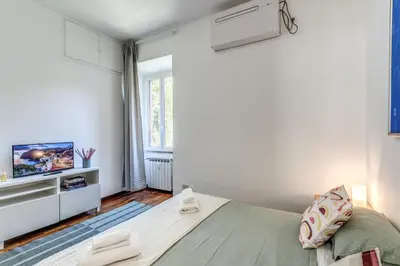 a small bedroom with a bed and a tv at Oasis Apartment Trastevere in Rome