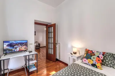 a living room with a couch and a desk with a computer at Oasis Apartment Trastevere in Rome