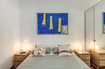 a bedroom with a bed with two night stands at Oasis Apartment Trastevere in Rome