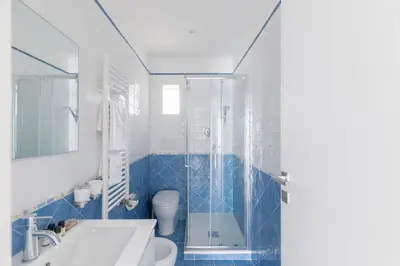 a bathroom with a shower and a toilet and a sink at HospitalityRome Sunny San Lorenzo in Rome