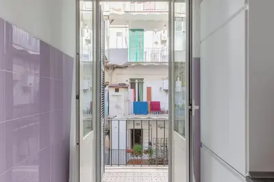 a sliding glass door with a view of a building at HospitalityRome Sunny San Lorenzo in Rome