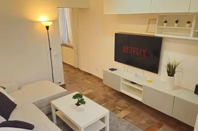 a living room with a couch and a flat screen tv at Cozy Modern Apartment with Terrace - Pantheon in Rome