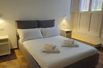 a bedroom with a bed with towels on it at Cozy Modern Apartment with Terrace - Pantheon in Rome