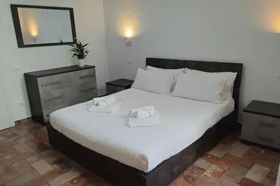 a bedroom with a large bed with two towels on it at Cozy Modern Apartment with Terrace - Pantheon in Rome