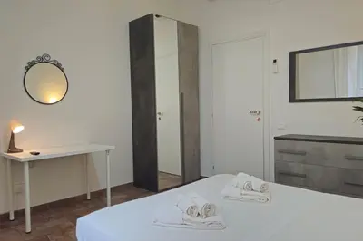 a bedroom with a bed with a desk and a mirror at Cozy Modern Apartment with Terrace - Pantheon in Rome