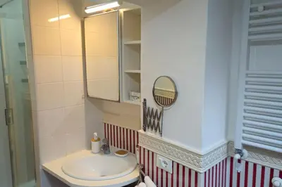 a bathroom with a sink and a mirror at Cozy Modern Apartment with Terrace - Pantheon in Rome