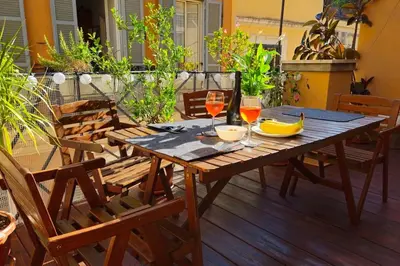 a wooden table with wine glasses and bananas on a patio at Cozy Modern Apartment with Terrace - Pantheon in Rome